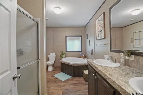 a bathroom with a granite countertop sink mirror and toilet
