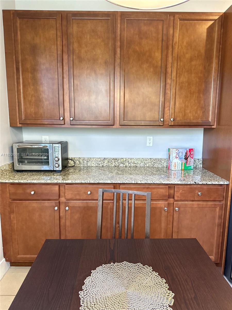 3278 West 97th Terrace Hialeah, FL 33018 - Photo 20 of 97 a kitchen with granite countertop wooden cabinets a sink and dishwasher