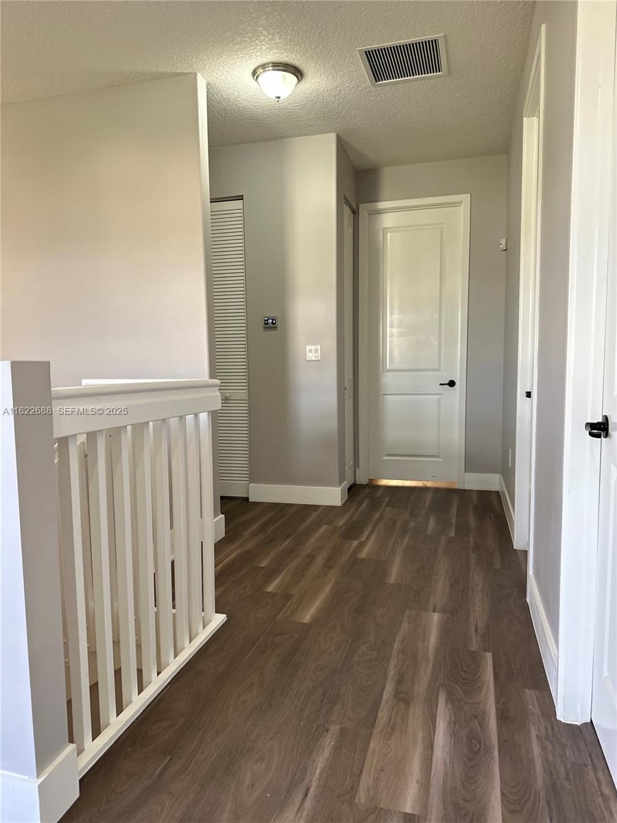 3278 West 97th Terrace Hialeah, FL 33018 - Photo 69 of 97 a view of a hallway with wooden floor
