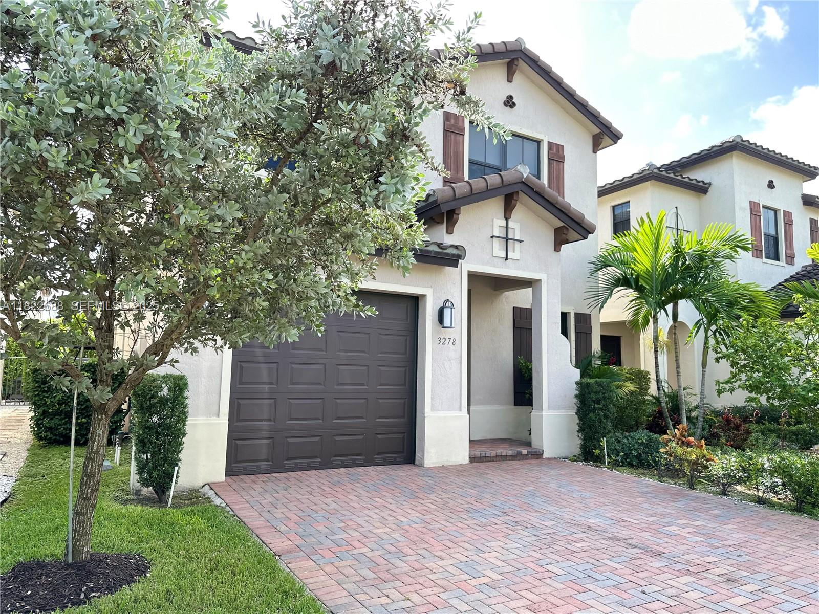 3278 West 97th Terrace Hialeah, FL 33018 - Photo 7 of 97 a front view of a house with a yard and garage