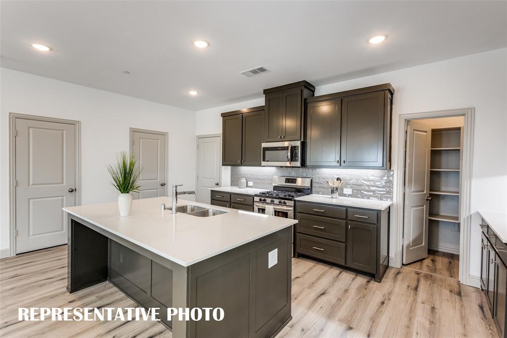 2844 Chisos Red Road McKinney, TX 75071 - Photo 6 of 13 The large kitchen island makes the perfect gathering place for family and friends! REPRESENTATIVE PHOTO.