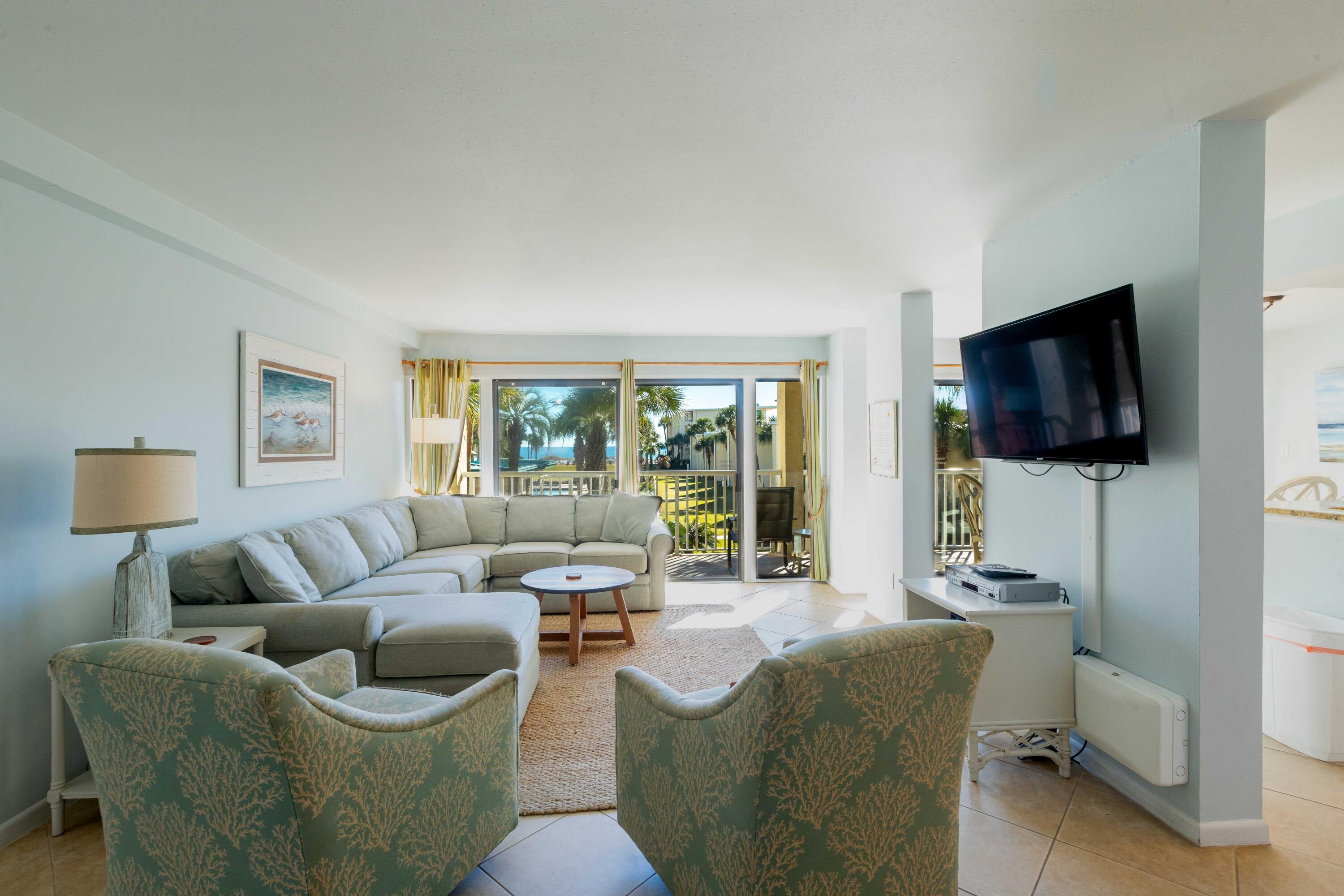1030 East E Highway, Unit 25 Destin, FL 32541 - Photo 4 of 34 a living room with furniture and a flat screen tv