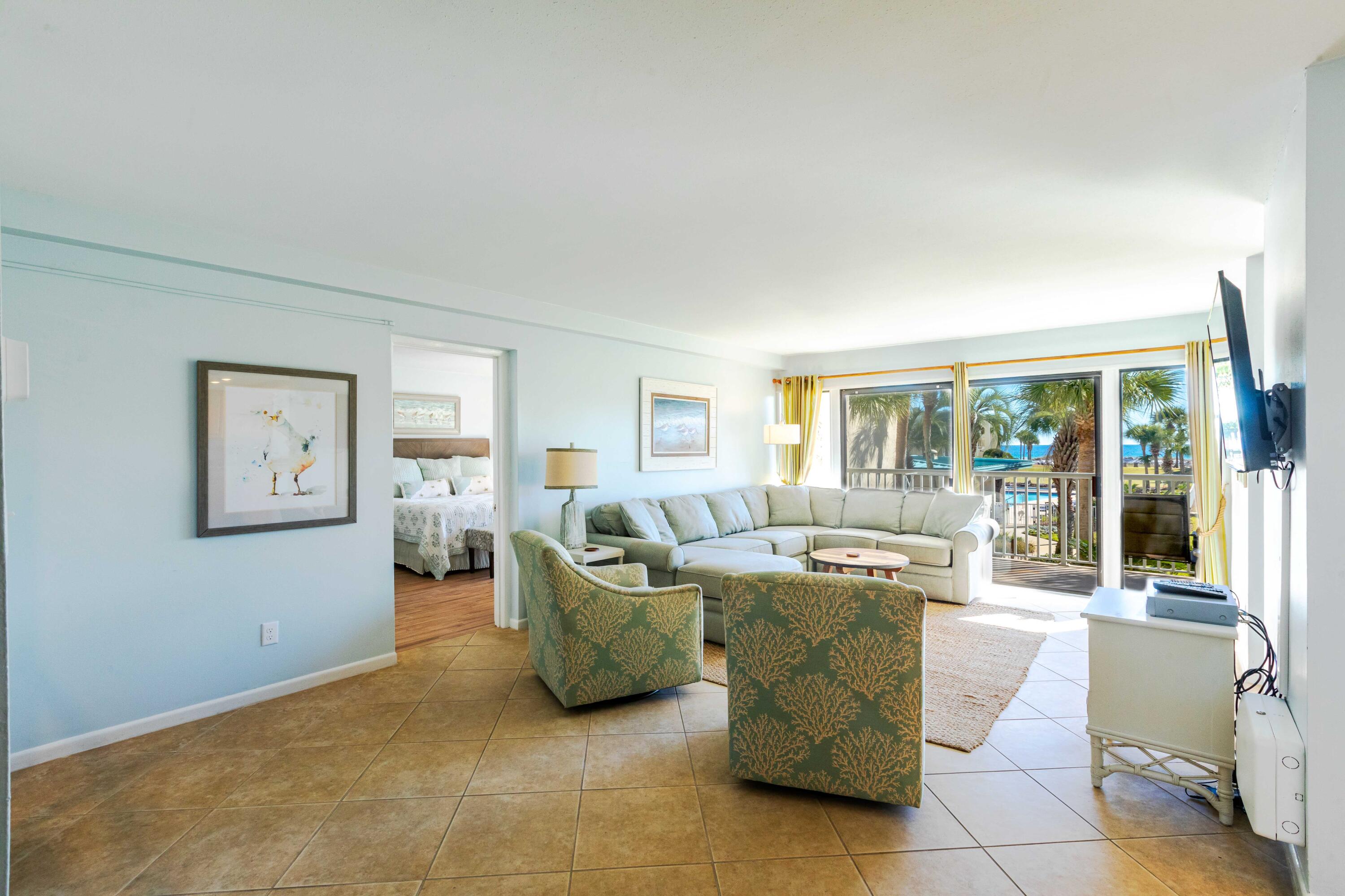 1030 East E Highway, Unit 25 Destin, FL 32541 - Photo 9 of 34 a living room with a couch and a table