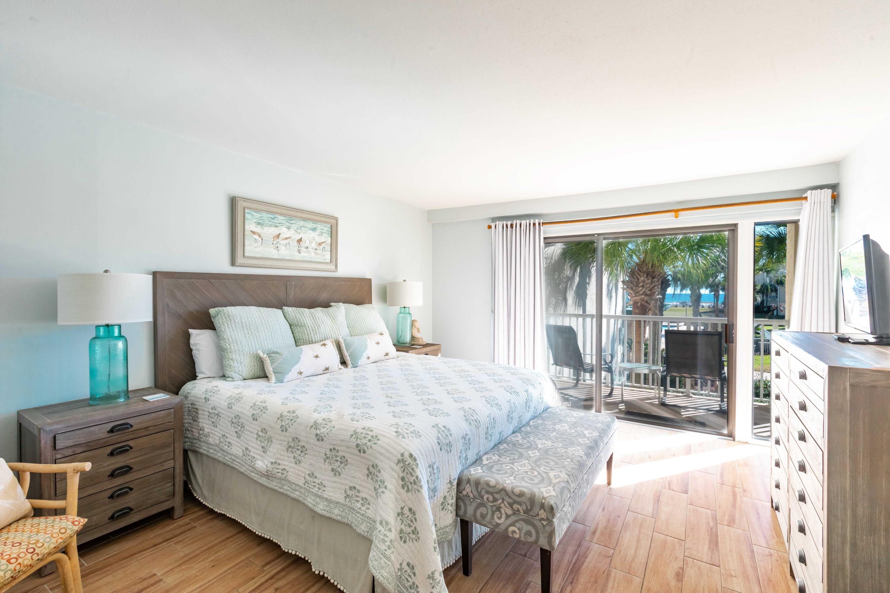 1030 East E Highway, Unit 25 Destin, FL 32541 - Photo 10 of 34 a bedroom with a bed and a large window with outer view