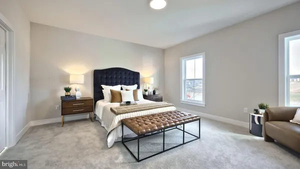 a large bedroom with a bed and a couch