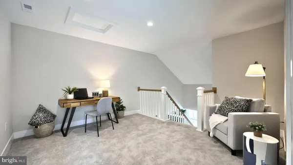 a spacious bedroom with a bed and a lamp