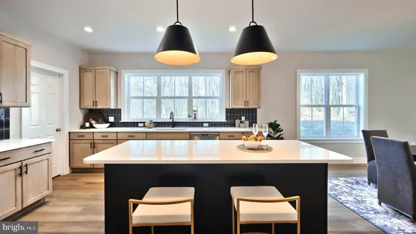 a kitchen with a table chairs sink and cabinets