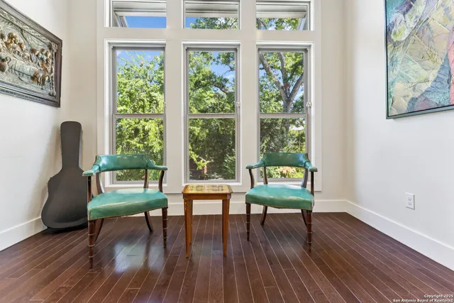 a kitchen that has a sink a table and chairs in it