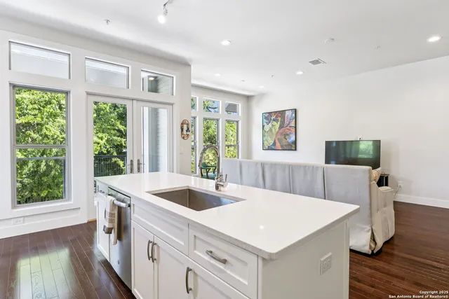 a view of a hallway with wooden floor and doors