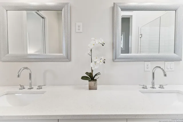 a bathroom with a shower and a sink