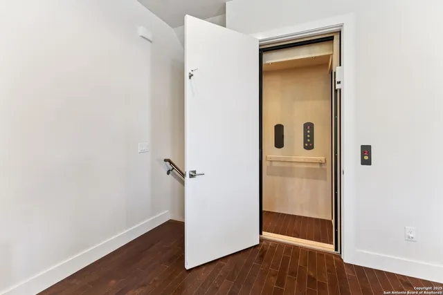 a living room with furniture and large windows