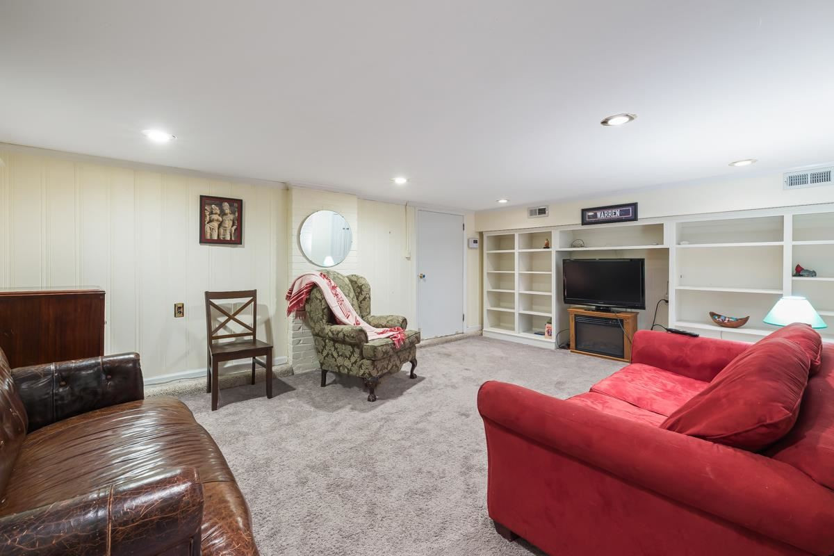 2506 Van Dyke Avenue Raleigh, NC 27607 - Photo 19 of 28 This great room in the basement has built in shelving and has exterior access through the garage. Den/Family/Great Room