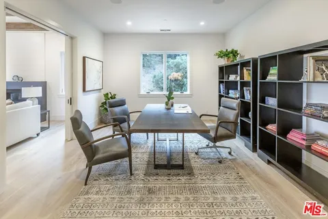 a living room with furniture a rug and a window
