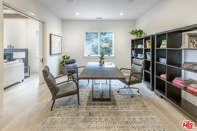 a living room with furniture a rug and a window