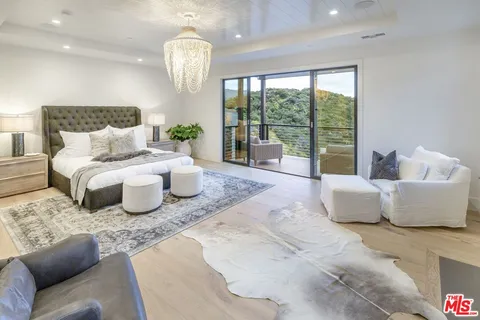 a bedroom with a bed and glass window