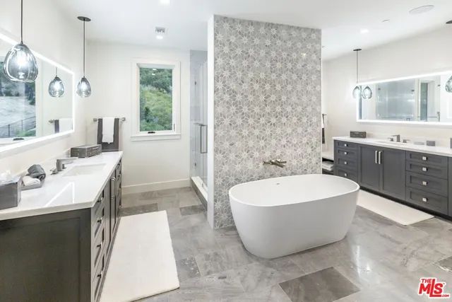 a spacious bathroom with a bathtub and a sink