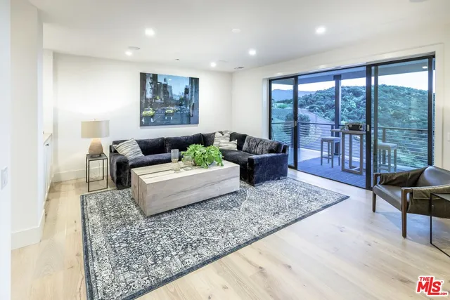 a view of a room with a large window and dining area