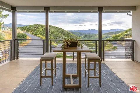 a hallway with a dining table and chairs