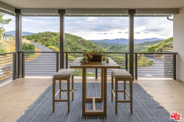 a hallway with a dining table and chairs