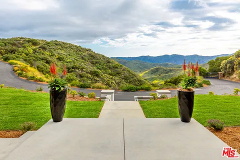 a view of swimming pool with outdoor seating and plants