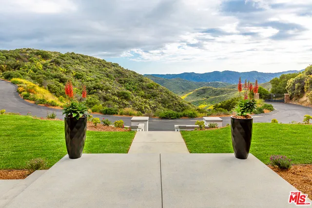 a view of swimming pool with outdoor seating and plants