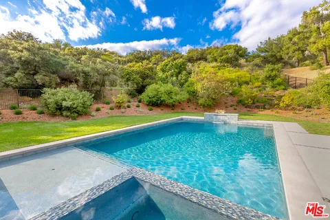 a swimming pool view with a outdoor seating