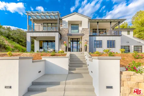 a front view of a house with a yard table and chairs