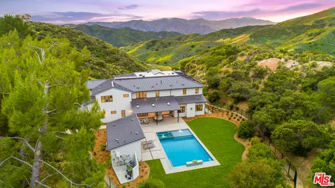an aerial view of a house with a garden