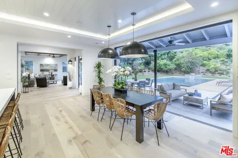 a view of a dining room with furniture window and outside view