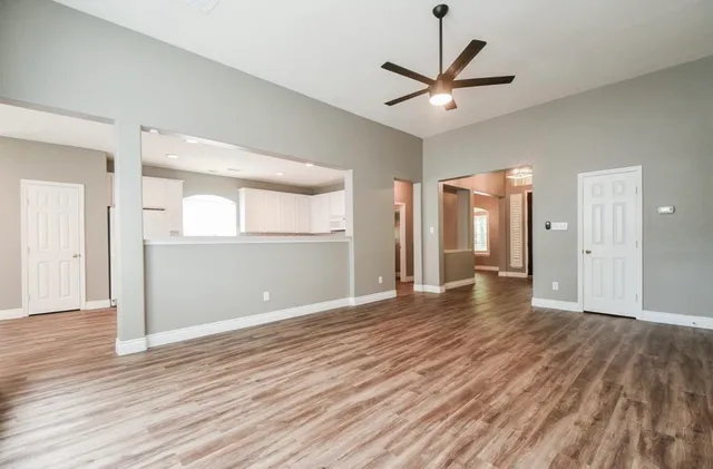 a view of a livingroom with a hardwood floor and a ceiling fan
