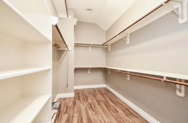 a view of a room with wooden floor