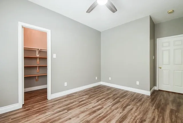 a view of room with wooden floor and closet