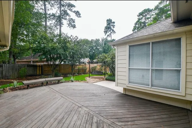 a view of outdoor space with wooden floor and fence