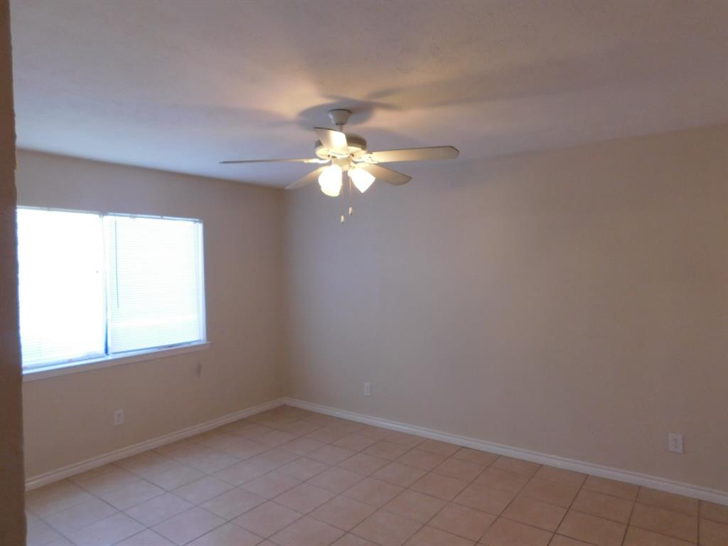 10371 White Elm Road Dallas, TX 75243 - Photo 10 of 11 Unfurnished room featuring light tile patterned flooring and a ceiling fan
