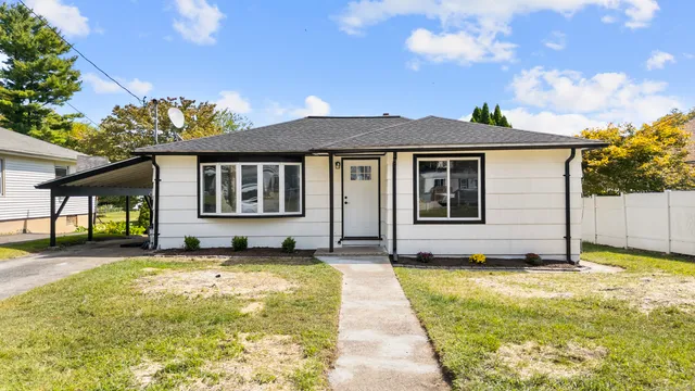 a view of a house with pool and yard