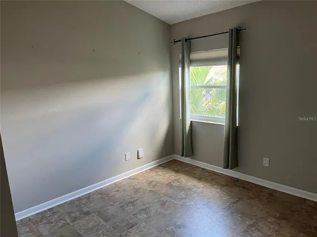 a view of staircase with white walls and a window