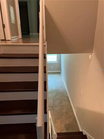 a bathroom with a granite countertop sink and mirror with toilet