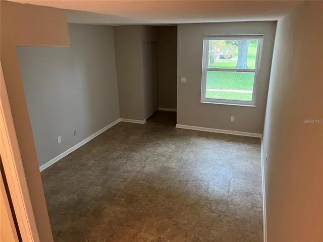 a bathroom with a granite countertop toilet and a sink
