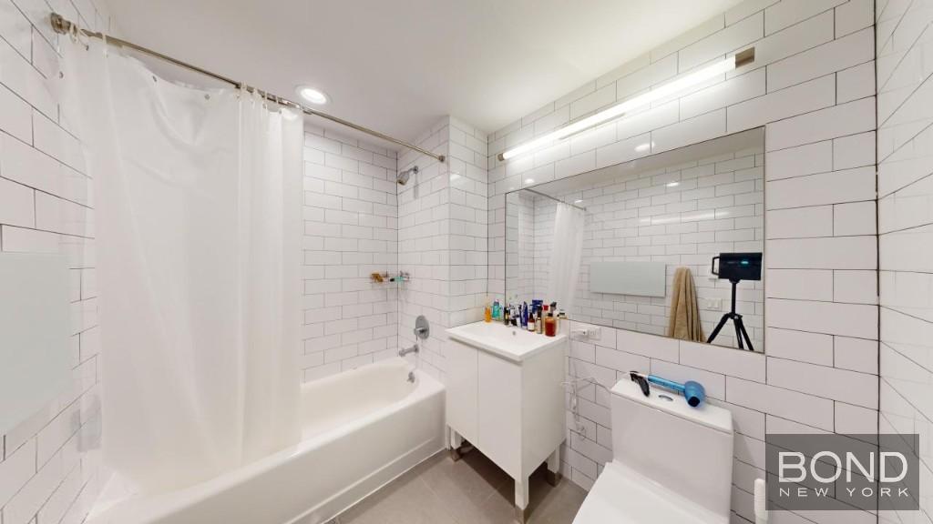 a bathroom with a bathtub a sink and a shower