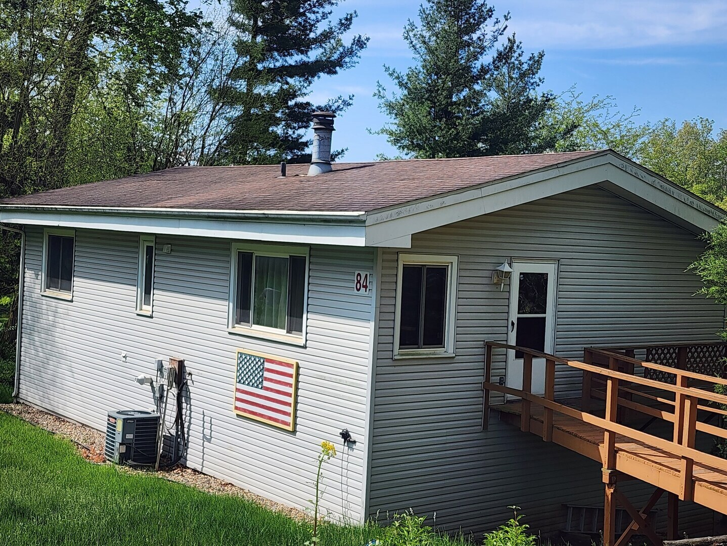 a front view of a house with a tree