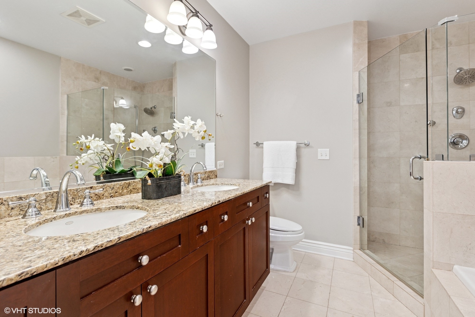 35 South Racine Avenue, Unit 6SE Chicago, IL 60607 - Photo 16 of 26 a bathroom with a granite countertop sink a toilet and a mirror