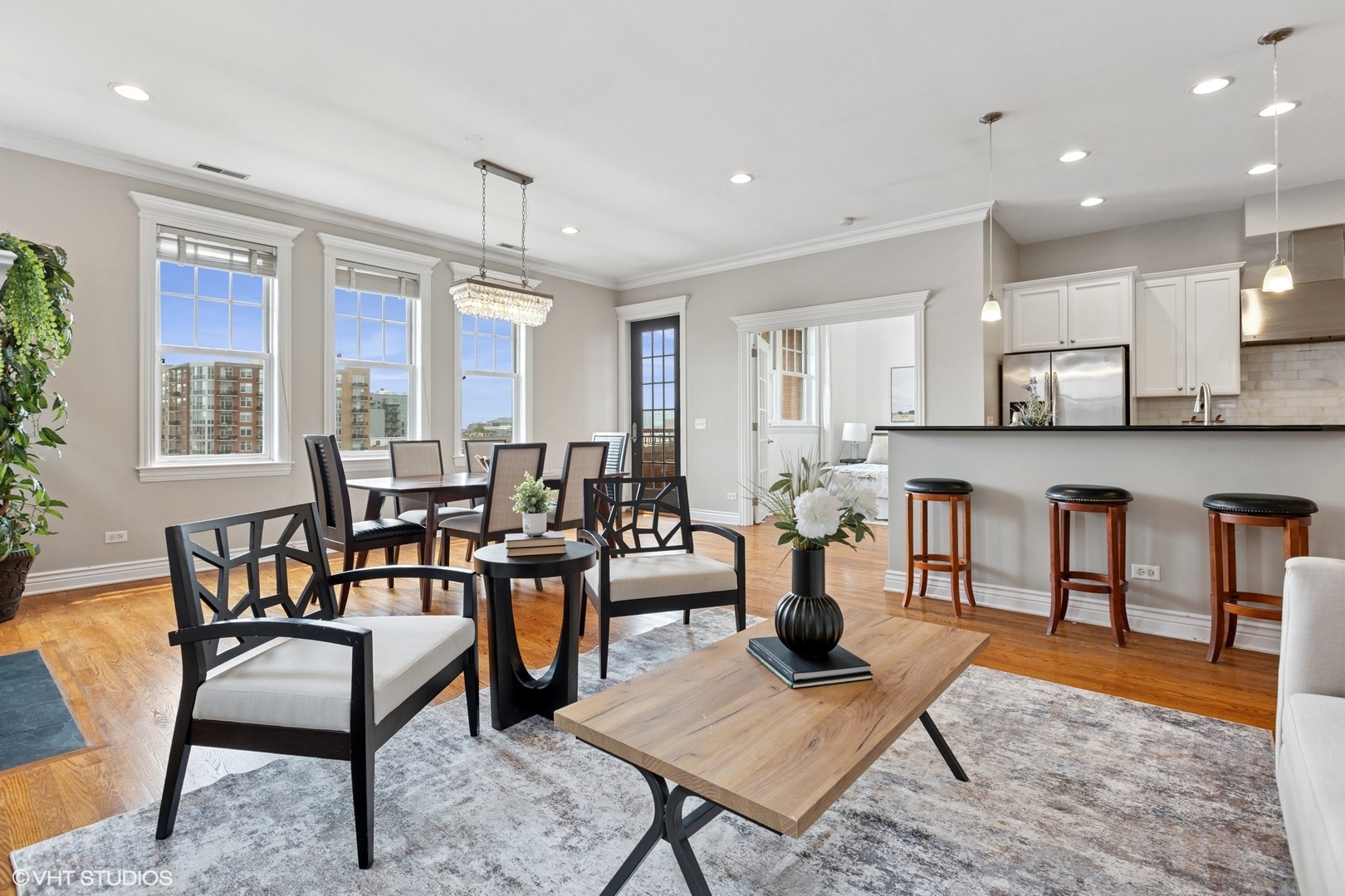 35 South Racine Avenue, Unit 6SE Chicago, IL 60607 - Photo 2 of 26 a living room with furniture a rug kitchen view and a large window
