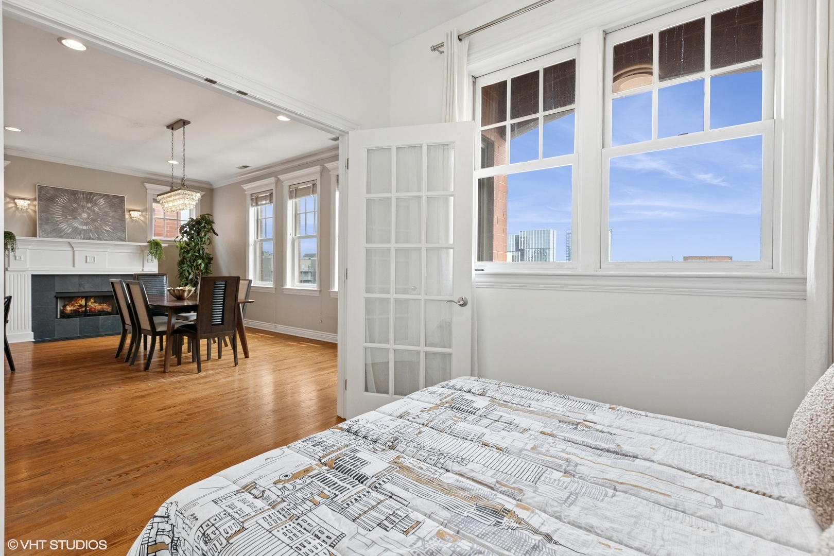 35 South Racine Avenue, Unit 6SE Chicago, IL 60607 - Photo 22 of 26 a bedroom with a bed and wooden floor