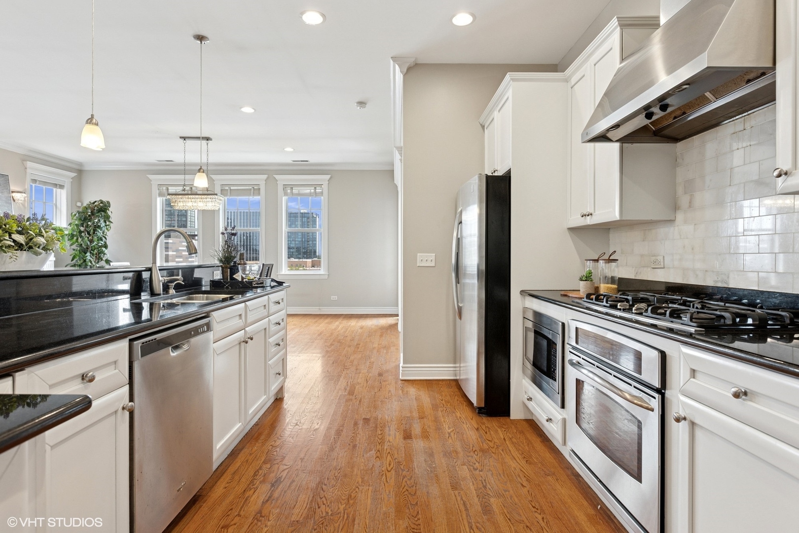 35 South Racine Avenue, Unit 6SE Chicago, IL 60607 - Photo 5 of 26 a kitchen with stainless steel appliances a sink dishwasher stove refrigerator and microwave