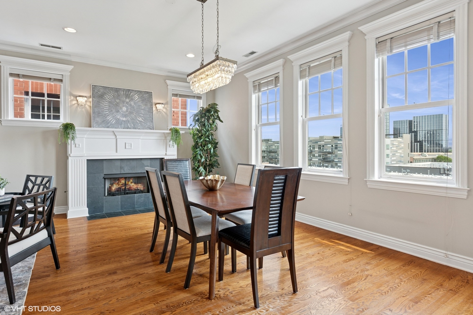 35 South Racine Avenue, Unit 6SE Chicago, IL 60607 - Photo 9 of 26 a dining room with furniture a chandelier and wooden floor