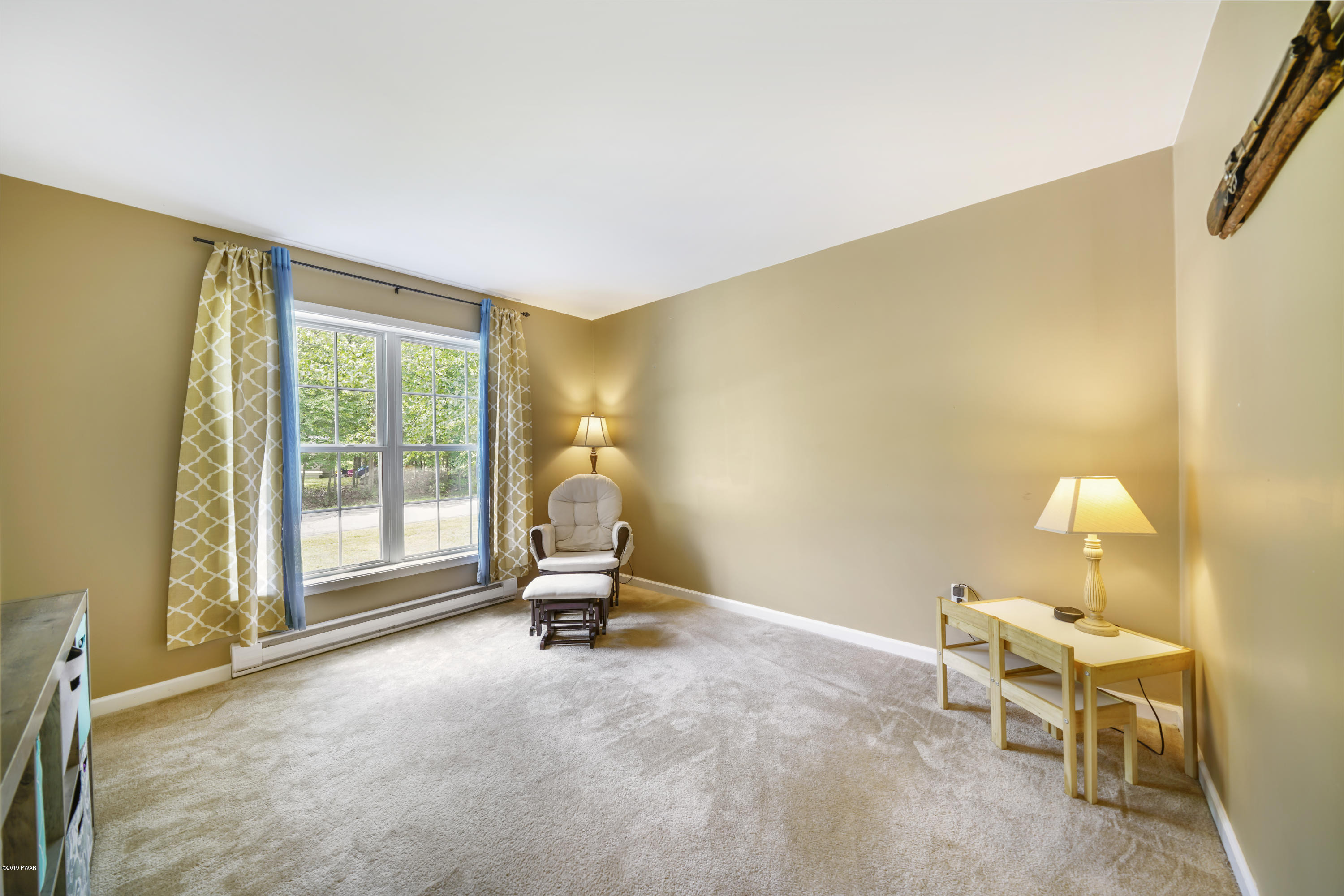 129 Butternut Road Milford, PA 18337 - Photo 18 of 26 a living room with furniture and a floor to ceiling window
