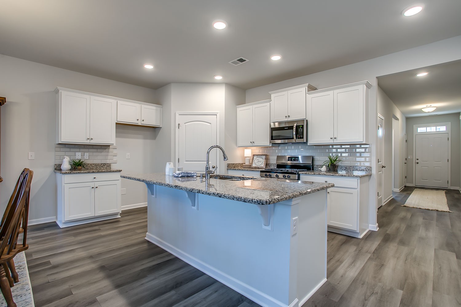 767 Prominence Road Columbia, TN 38401 - Photo 5 of 38 a kitchen with kitchen island granite countertop white cabinets a sink and stainless steel appliances
