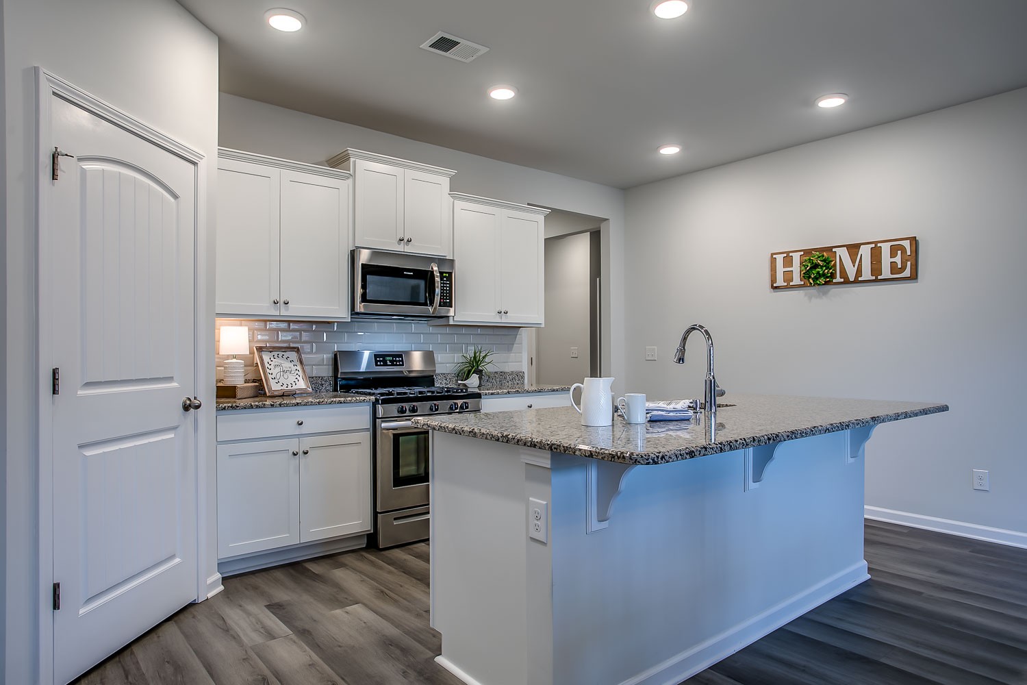 767 Prominence Road Columbia, TN 38401 - Photo 6 of 38 a kitchen with kitchen island granite countertop a sink stainless steel appliances and white cabinets
