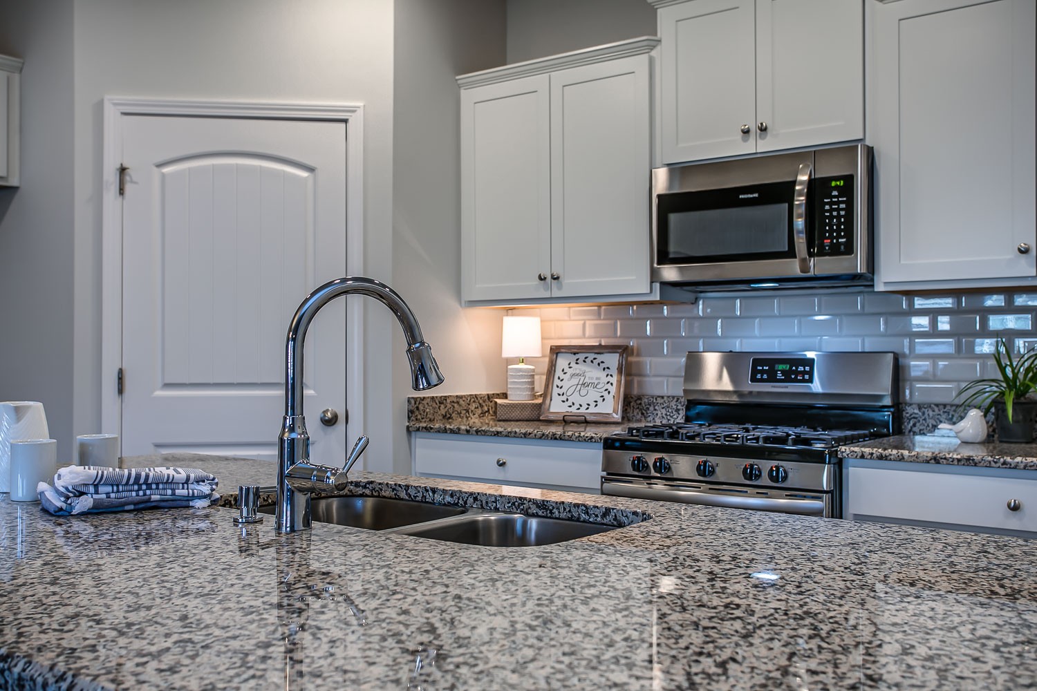 767 Prominence Road Columbia, TN 38401 - Photo 9 of 38 a kitchen with stainless steel appliances granite countertop a stove a sink and a microwave