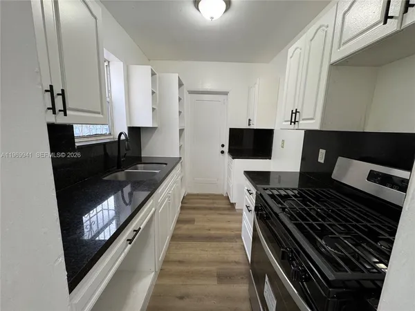 a kitchen with stainless steel appliances a stove and a refrigerator
